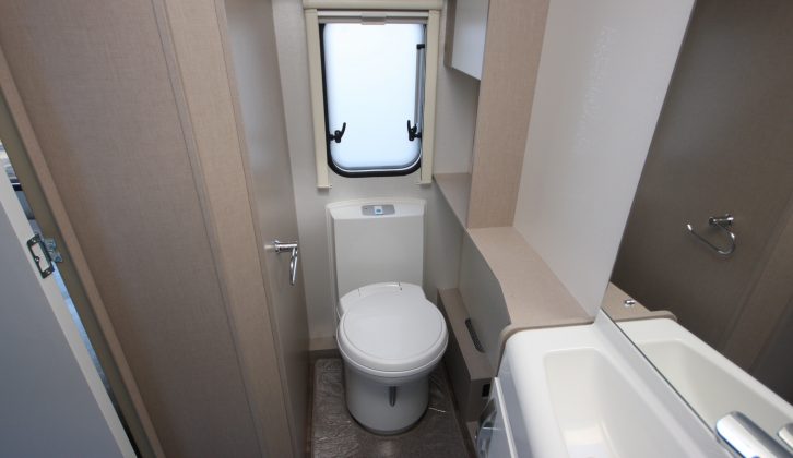 Space around the Thetford electric flush toilet is pretty tight in this van's washroom