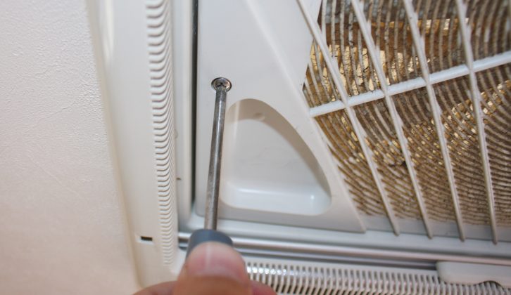 2 Remove the four crosshead screws that hold the lower slatted grille in place