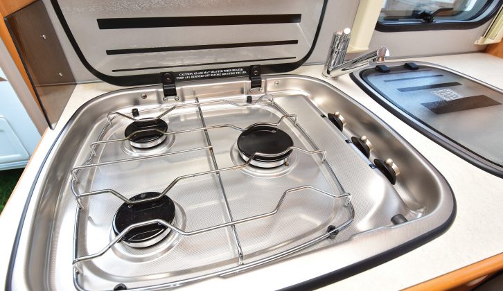 The immaculate stainless-steel hob had three gas burners and a glass lid that you can use as an additional work surface