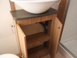 There's plenty of room to store toiletries in this cupboard beneath the sink in the end-washroom