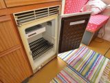 The nearside kitchen has a two-ring gas hob, gas grill, plastic sink (with foot pump) and fridge