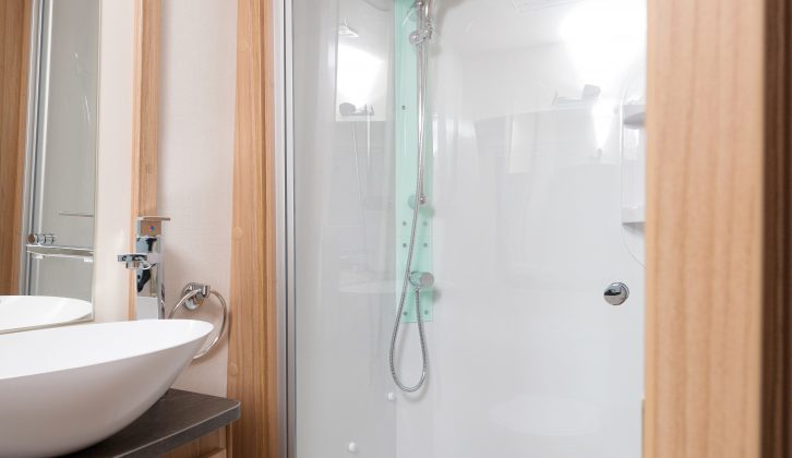 There's a fully-lined shower cubicle, vanity unit, shelves, a roof vent, towel rail and basin
