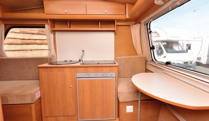 The Freedom's rear dinette is narrow and awkward to use, but the kitchen does have two shallow roof lockers