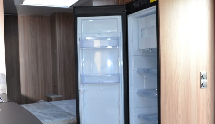 The slim-line Dometic fridge-freezer is located opposite the main kitchen area