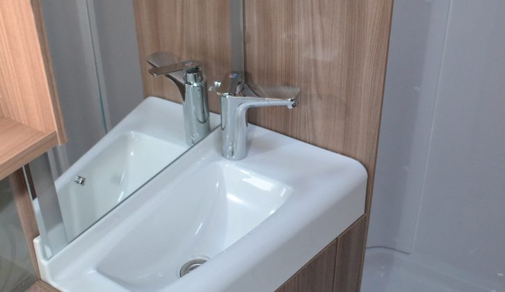 The angular plastic basin has a nice-looking chrome tap, plus there's a mirror behind