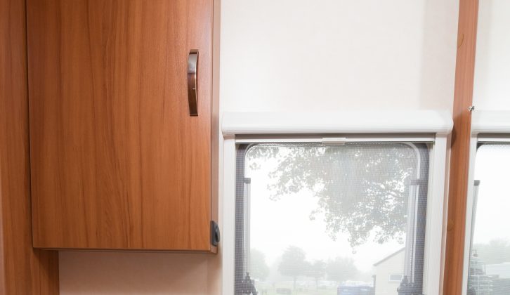 A window lets light flood into the washroom, plus there's this good-sized cupboard – read more in the Practical Caravan Weinsberg CaraOne 400 LK review