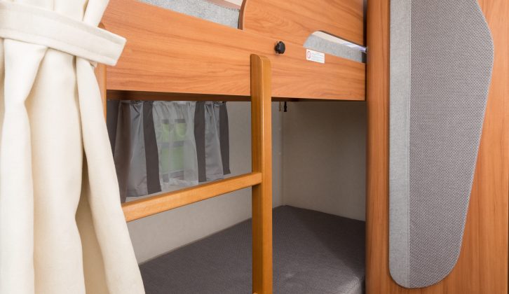 Bunk beds run across the rear of the van, a fixed ladder giving access to the upper one