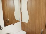 The 'wave' motif in the washroom helps to lighten the wooden walls