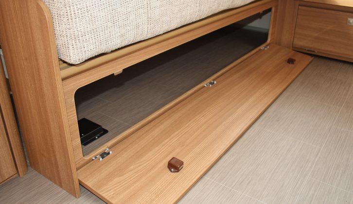 You can store items under the sofas, which have drop-down flaps with positive catches