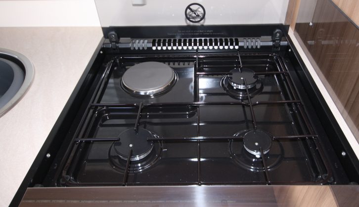 Three gas rings and a hob grace the top of the full cooker and grill