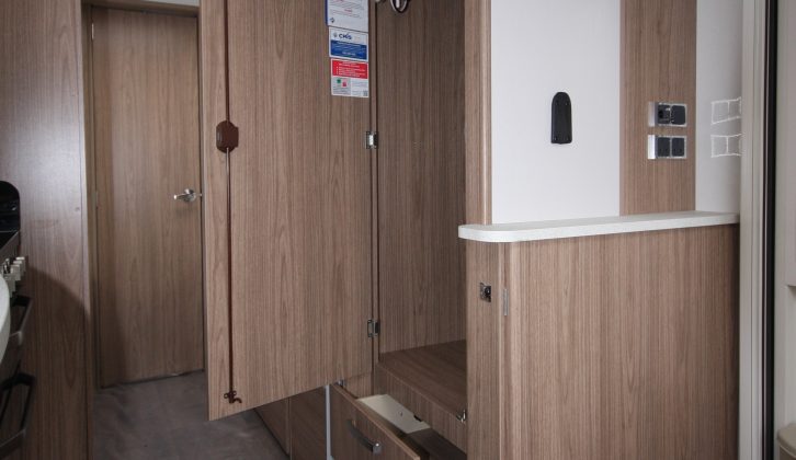 A good-sized wardrobe sits opposite the kitchen, while the feature panel on the wall by the door has sockets and a TV mounting point