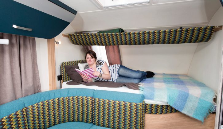 The rear fixed double bed has one reading light and the curved wall means only one can sit up in bed