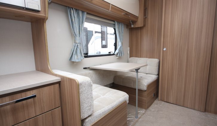 The dinette sits opposite the kitchen, on the caravan's offside