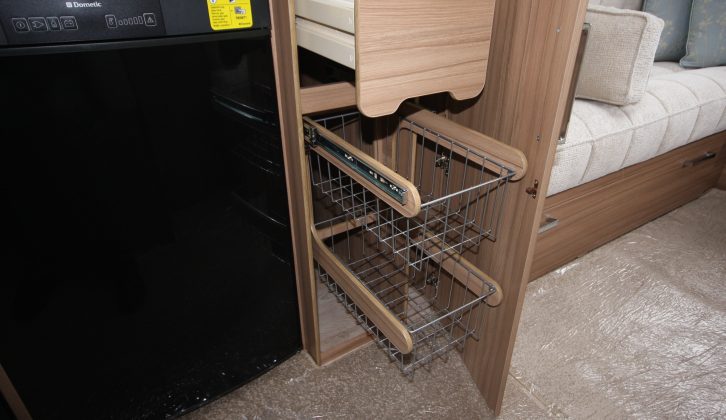 The compartment next to the fridge is where the freestanding table is stowed, plus it has a drawer and useful racking