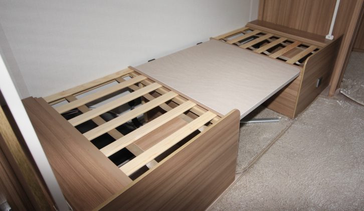 You pull out slats and use the table to create the lower bunk in the dinette area