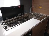 There are three gas burners and a square stainless-steel sink in the Loire's kitchen