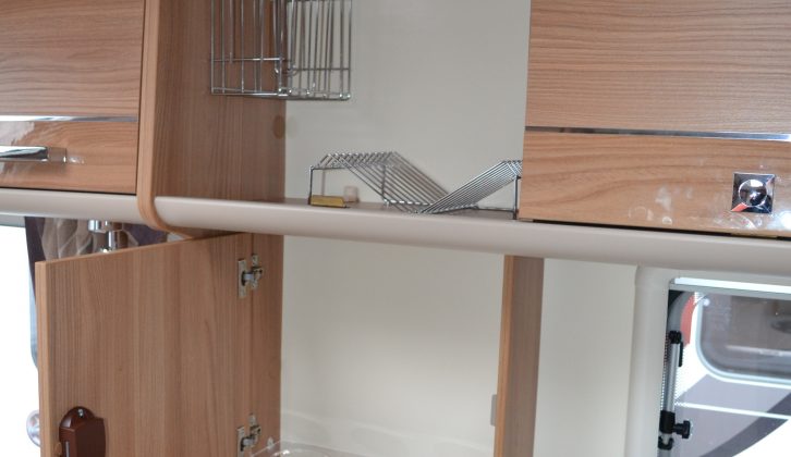 Cupboard space for crockery, a shallow cupboard for bottles and two plug sockets