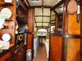 The mirrored wardrobe door on the right closes across the van to separate the bedroom from the living area