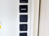 One of the few 230V sockets in this van is in this tower in the kitchen, which also includes heating and mains controls