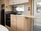 The Elddis Avanté 866 has a well-equipped kitchen with plenty of cupboards, drawers and worktop, plus an extension flap that goes across the entrance door rather than across a sofa