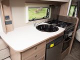 It is a good-sized kitchen which gives caravanners a dual-fuel hob, a fridge, and a separate oven and grill