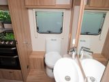 The electric-flush swivel toilet is positioned on the offside of the central washroom