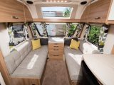 Plenty of light enters the lounge of this Sprite caravan via the sunroof, which has speakers on either side