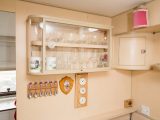 Here's the cabinet for drinking glasses – below it hang a selection of tea spoons and plaques