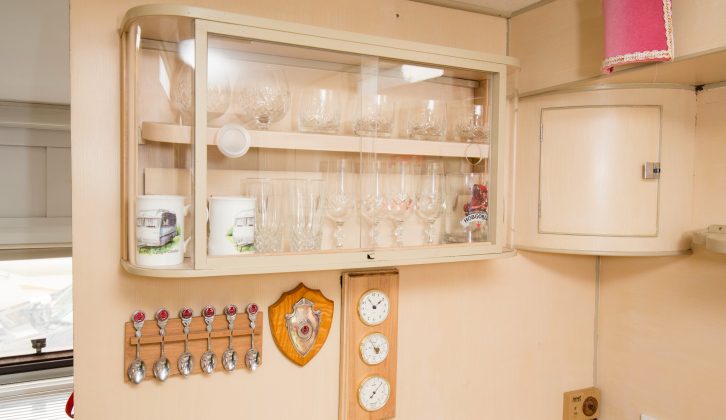 Here's the cabinet for drinking glasses – below it hang a selection of tea spoons and plaques