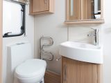 The good-sized washroom has cupboards and shelves rather than worktop space around the basin