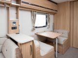 A neat dinette sits opposite the kitchen – read more in the Practical Caravan Coachman Pastiche 520 review