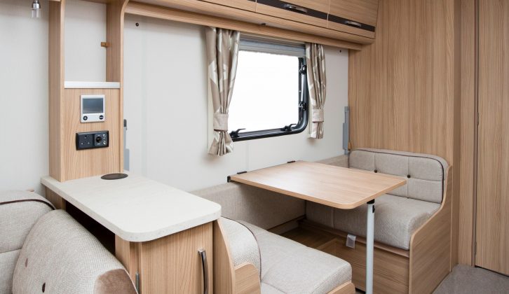 A neat dinette sits opposite the kitchen – read more in the Practical Caravan Coachman Pastiche 520 review