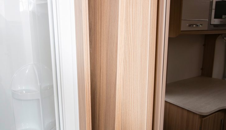 The freestanding lounge table is stored in a high slot cupboard, located just inside the washroom door