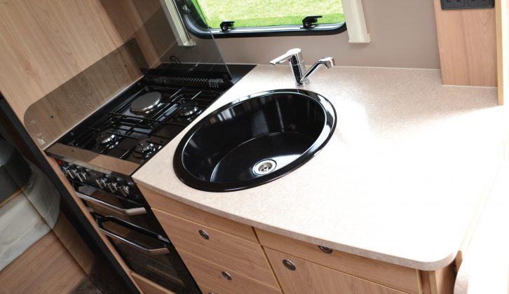 There’s plenty of workspace in the well-lit kitchen – the dark-coloured sink looks smart, too