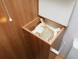Thoughtful touches in this Bailey caravan include this laundry bin in the washroom