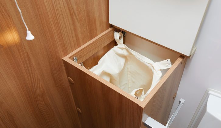 Thoughtful touches in this Bailey caravan include this laundry bin in the washroom