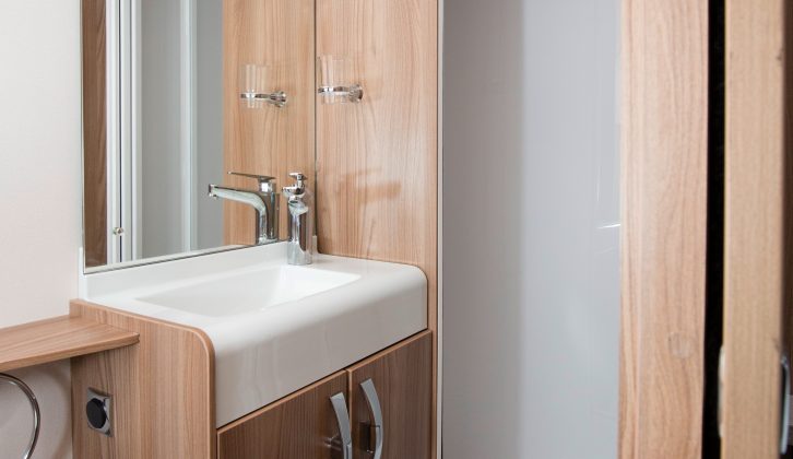 The fully lined shower cubicle is large and has shelves to perch your toiletries on