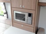 The microwave is neatly integrated and is set at an easy-to-use height