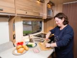The kitchen in this Bailey caravan is designed around the gas locker’s location on the offside, creating a slight L-shape and giving depth to the worktop, plus there’s space for panhandles on both sides of the hob