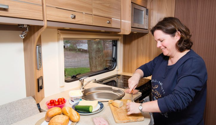 The kitchen in this Bailey caravan is designed around the gas locker’s location on the offside, creating a slight L-shape and giving depth to the worktop, plus there’s space for panhandles on both sides of the hob
