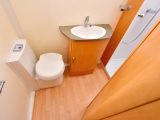 Storage is minimal but floor space is good in the full-width end washroom of this Olympus