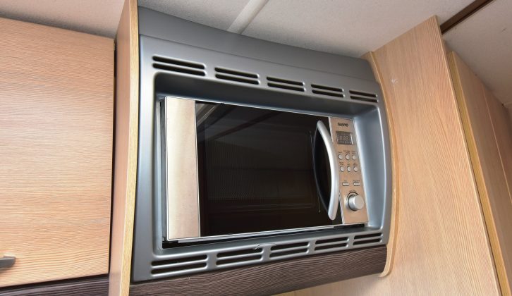 The microwave in the Sterling has dedicated housing, although it is sited over the hob
