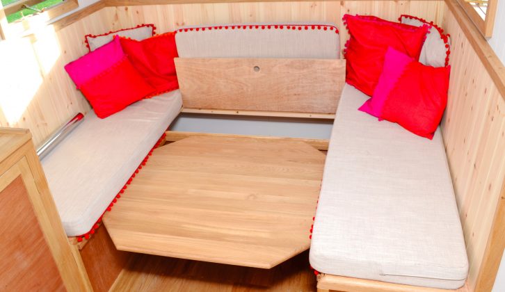The rear lounge can be made into a double bed, lowering the pedestal table to use as the bed base