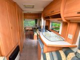 The rear dinette can be left as a double bed if needed, or a fold-up rear bunk adds a fifth berth