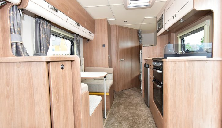 Looking rearward, the Compass Casita 586 has deep overhead roof lockers and feels spacious, plus the light wood trim keeps it neutral