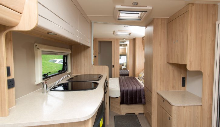 Wooden overhead lockers in the lounge, white in the kitchen, to give each area a distinct character