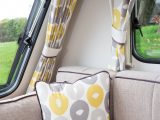 The cheerful yellow and oatmeal/grey fabrics give the lounge a fresh, bright, contemporary ambience