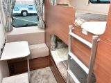 Young children will love using this small seat and table by the rear bunk pods, each of which has its own window and curtain