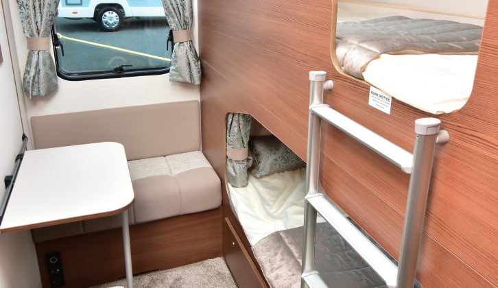 Young children will love using this small seat and table by the rear bunk pods, each of which has its own window and curtain