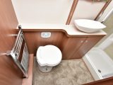 The washroom isn’t particularly large, but it includes a salad-bowl washbasin, a heated towel rail and a Thetford cassette loo with a concealed cistern